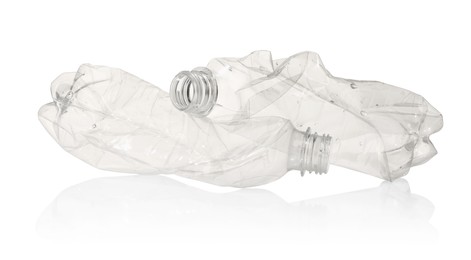 Photo of Crumpled disposable plastic bottles isolated on white