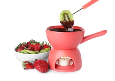 Fondue pot with chocolate, berries and fruits isolated on white