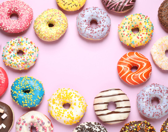 Photo of Delicious glazed donuts on lilac background, flat lay. Space for text