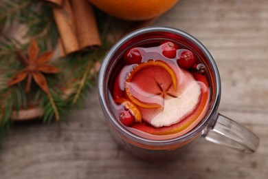 Aromatic mulled wine in glass cup on table, top view