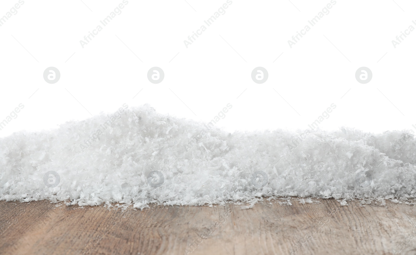 Photo of Heap of snow on wooden surface against white background. Christmas season