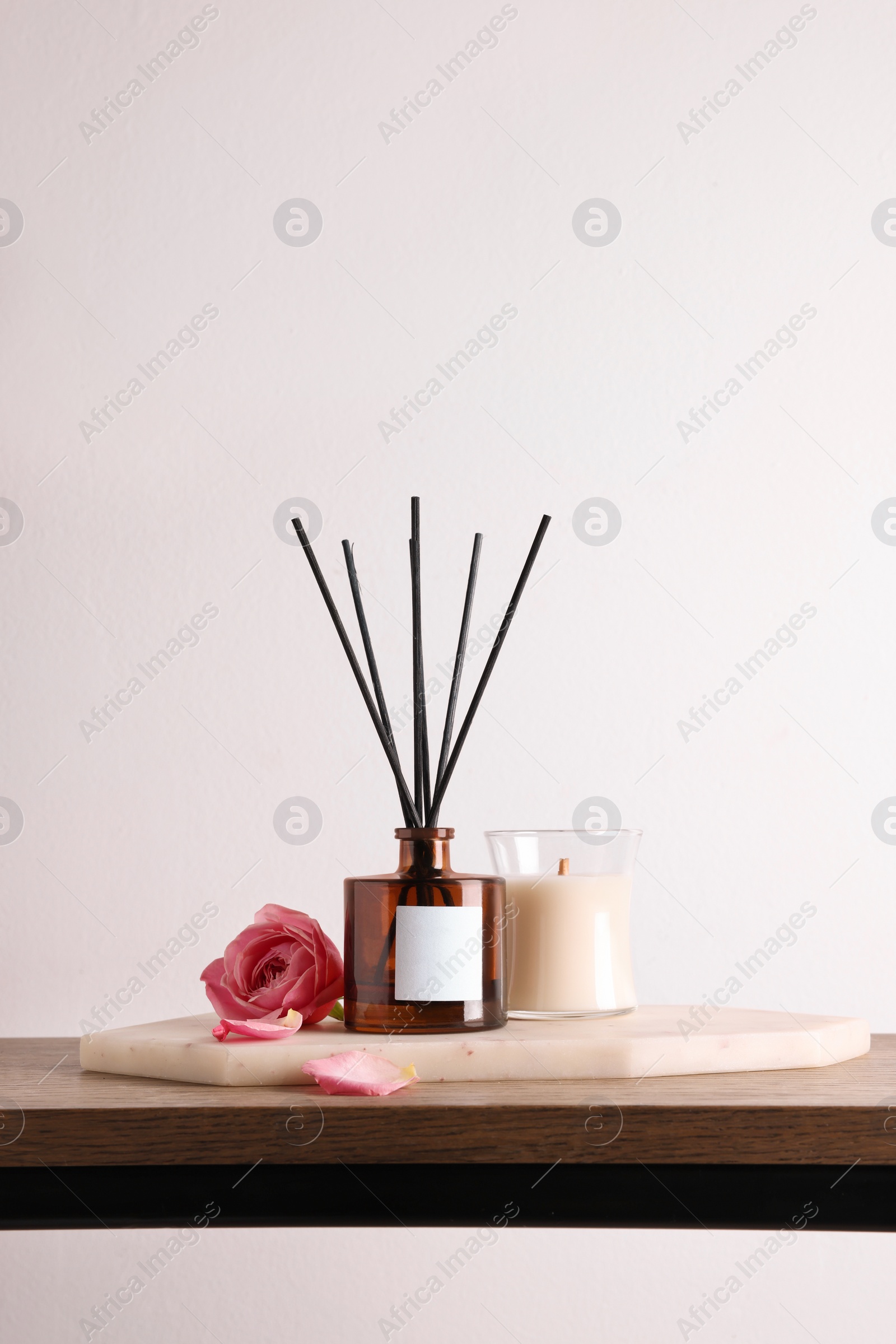 Photo of Composition with aromatic reed air freshener on wooden table