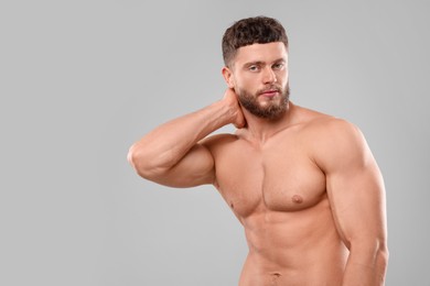 Photo of Handsome muscular man on light grey background, space for text. Sexy body