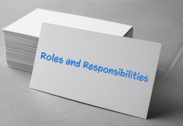 Image of Sheet of paper with text Roles and Responsibilities on grey stone table