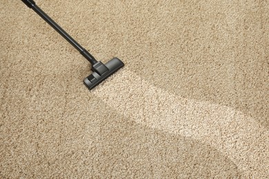 Hoovering carpet with vacuum cleaner, above view and space for text. Clean trace on dirty surface