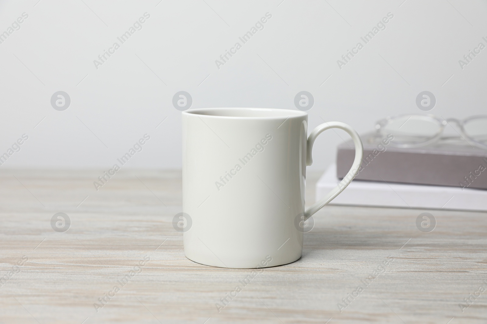 One ceramic mug on white wooden table Photo of One ceramic mug on white wooden table