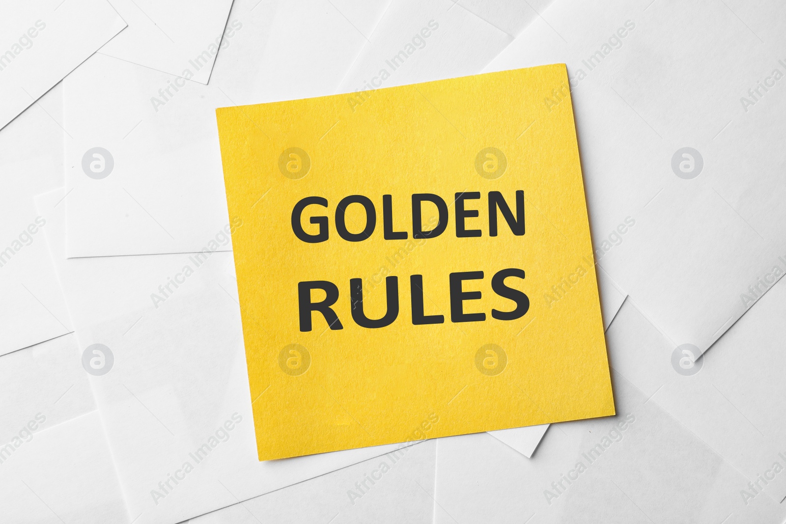 Image of Note with words GOLDEN RULES on paper sheets, top view