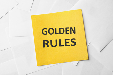Image of Note with words GOLDEN RULES on paper sheets, top view