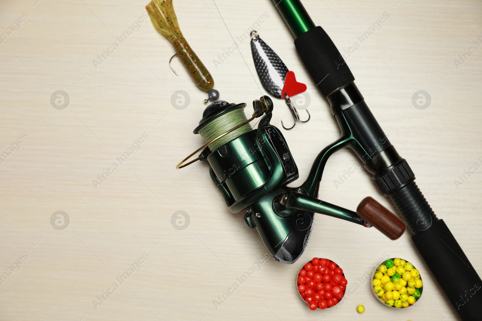 Photo of Fishing tackle on wooden background, flat lay. Space for text