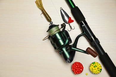 Fishing tackle on wooden background, flat lay. Space for text