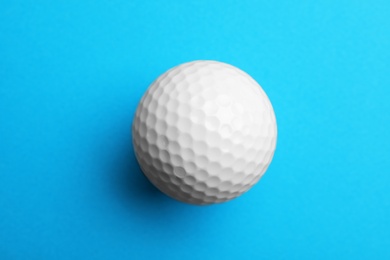 Photo of Golf ball on color background, top view. Sport equipment
