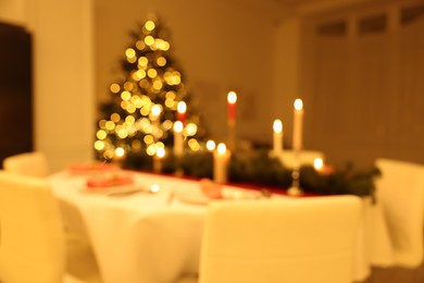 Photo of Blurred view of festive table setting and beautiful Christmas decor indoors. Interior design