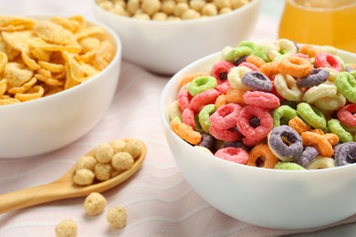 Different breakfast cereals on fabric, closeup view