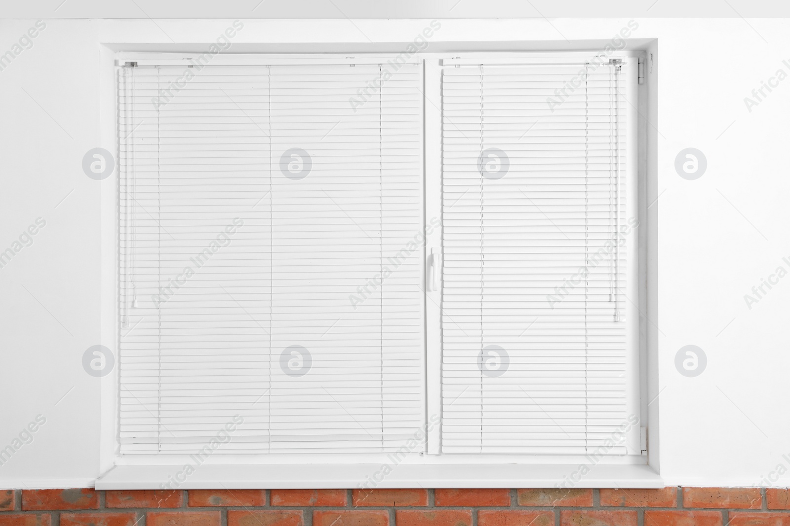 Photo of Modern window with closed blinds in room