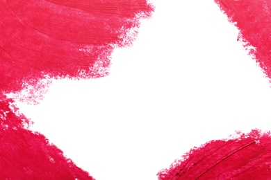 Strokes of lipstick on white background, top view. Space for text