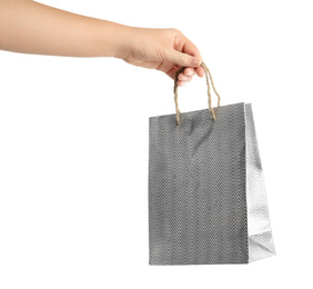 Woman holding silver paper shopping bag on white background, closeup. Space for design