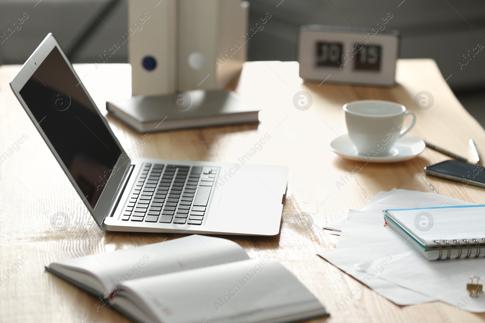 Photo of Modern laptop and supplies on table in office