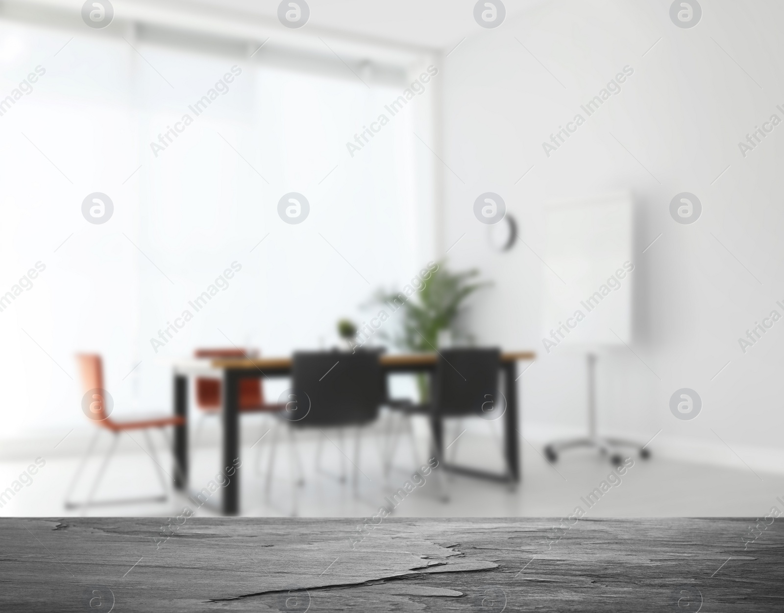 Image of Empty stone surface and blurred view of modern office interior, closeup. Space for text 