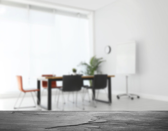 Empty stone surface and blurred view of modern office interior, closeup. Space for text 