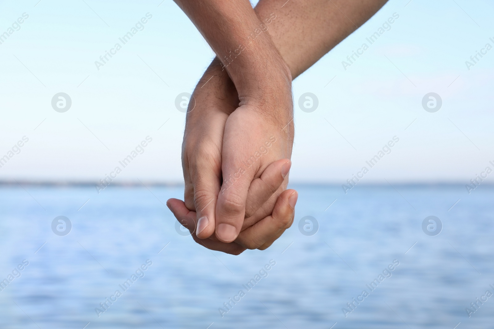 Photo of Gay couple near river on sunny day, closeup