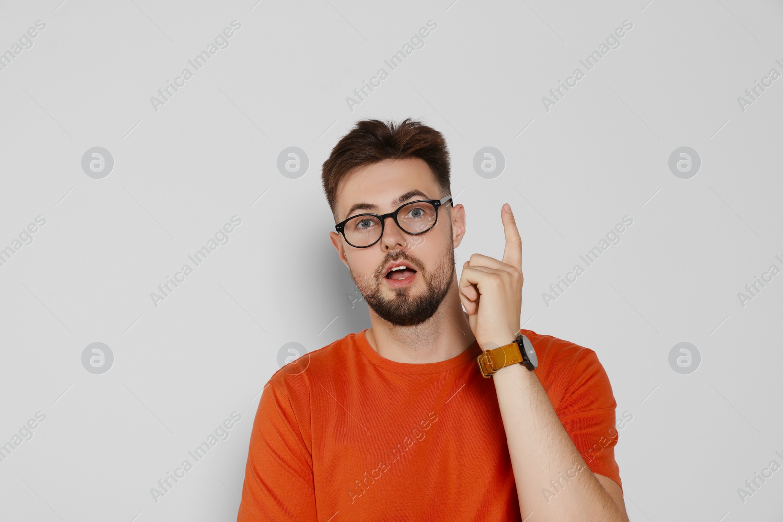 Photo of Enlightened man in eyeglasses on light grey background