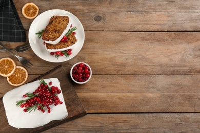 Photo of Flat lay composition with traditional classic Christmas cake on wooden table. Space for text