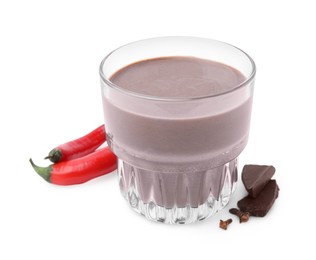 Photo of Glass of hot chocolate with chili peppers on white background