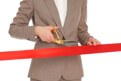 Photo of Woman in office suit cutting red ribbon isolated on white, closeup