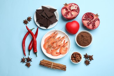 Photo of Natural aphrodisiac. Different products and heart model on light blue background, flat lay