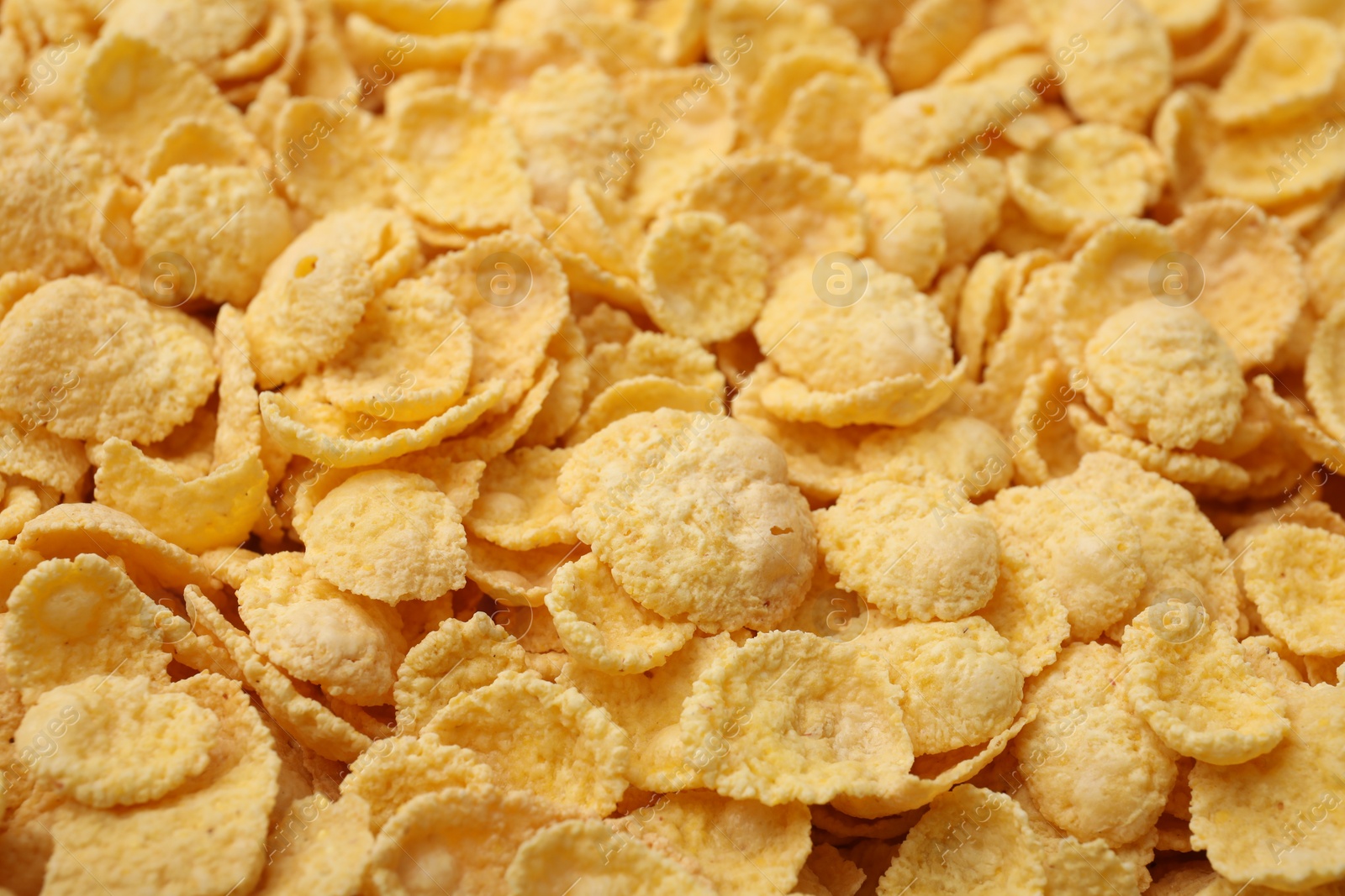 Photo of Breakfast cereal. Tasty sweet corn flakes as background, closeup