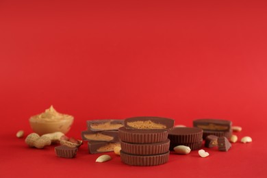 Photo of Sweet peanut butter cups on red background