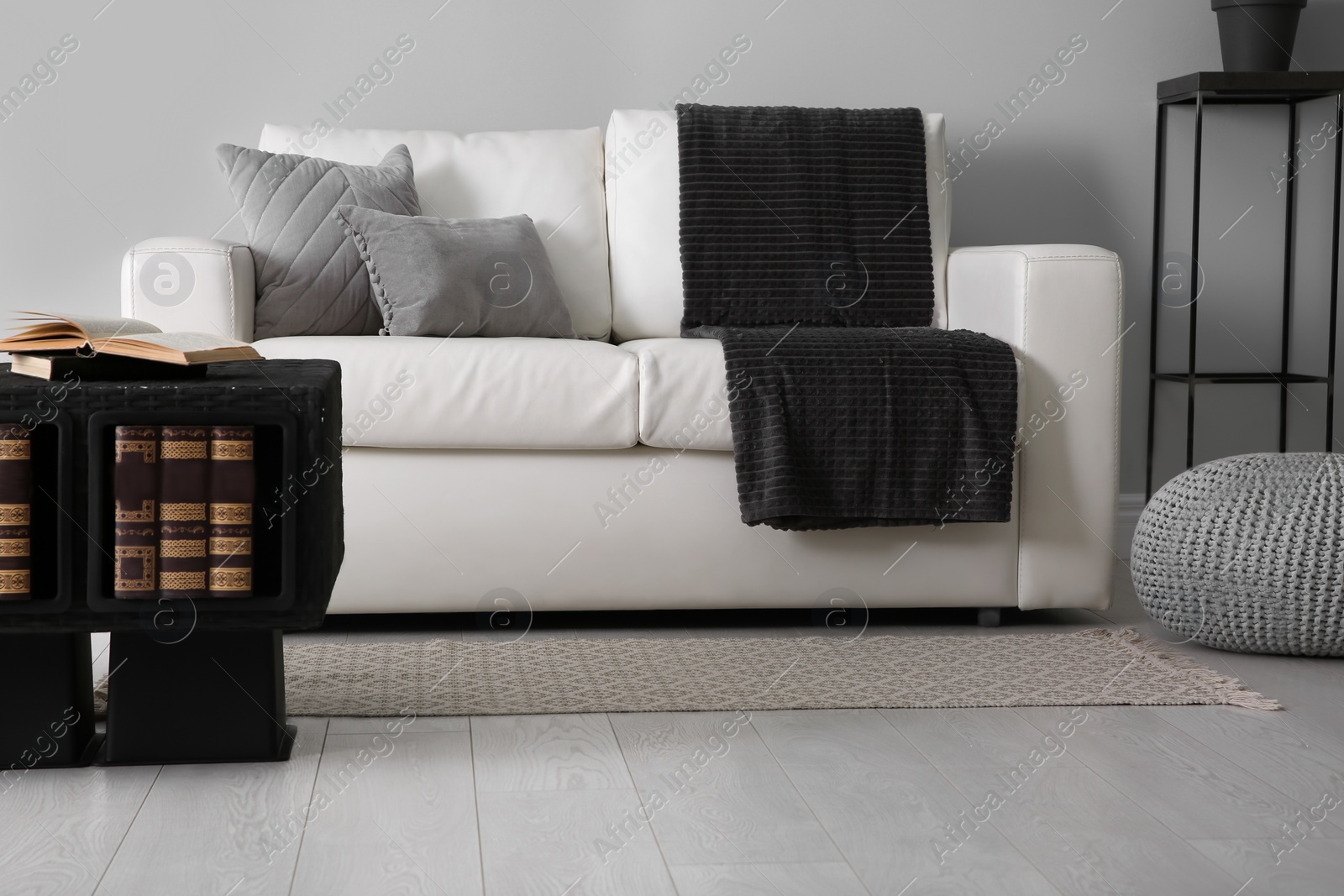 Photo of Modern comfortable sofa in stylish living room interior