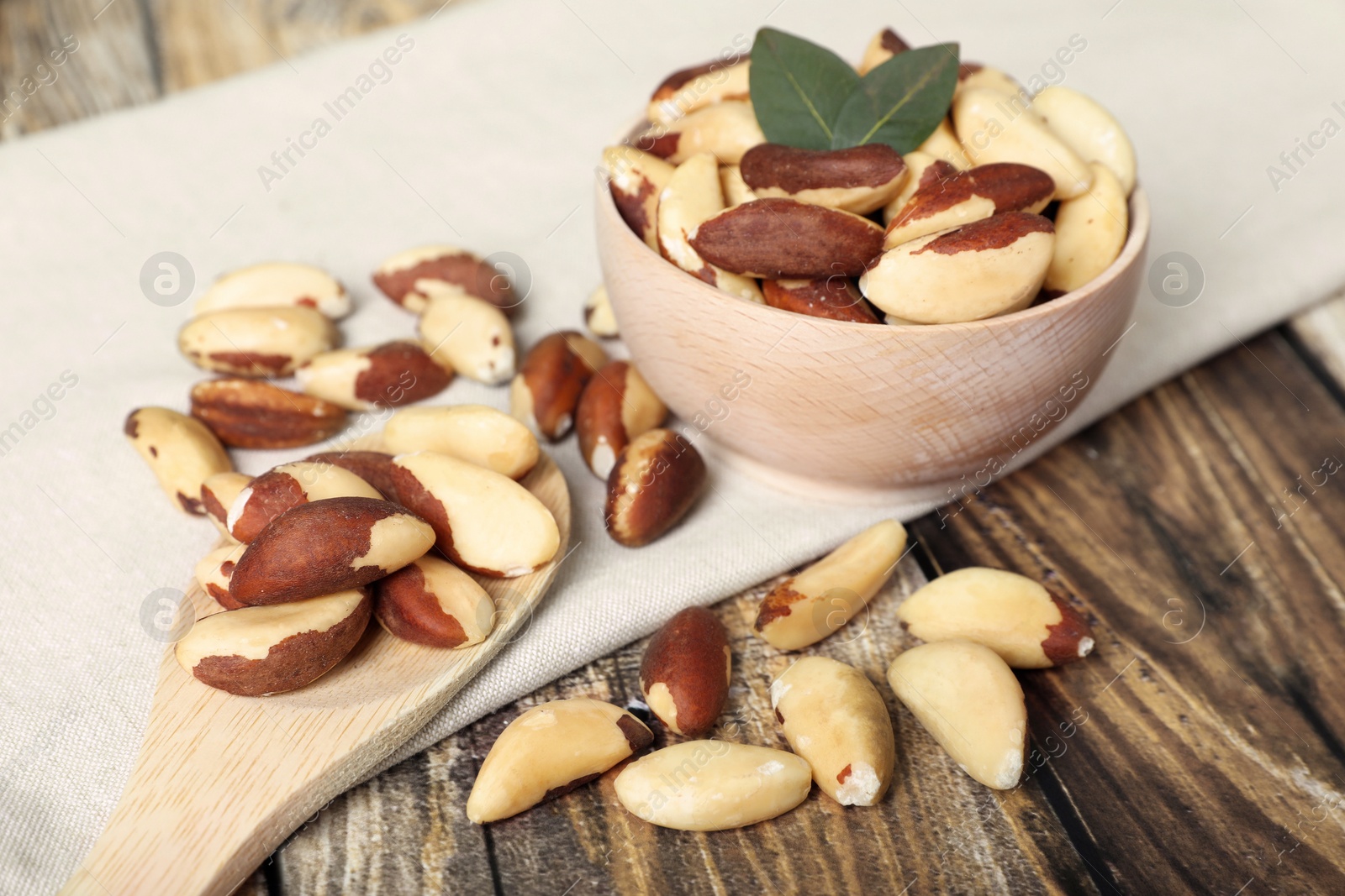 Photo of Many delicious Brazil nuts on wooden table