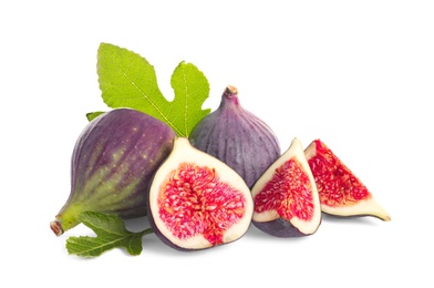 Photo of Whole and cut purple figs on white background