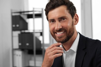 Photo of Portrait of smiling bearded man in office