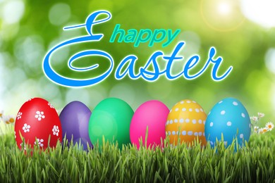 Image of Happy Easter. Bright eggs on green grass outdoors