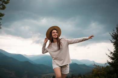 Photo of Young woman enjoying her time in mountains