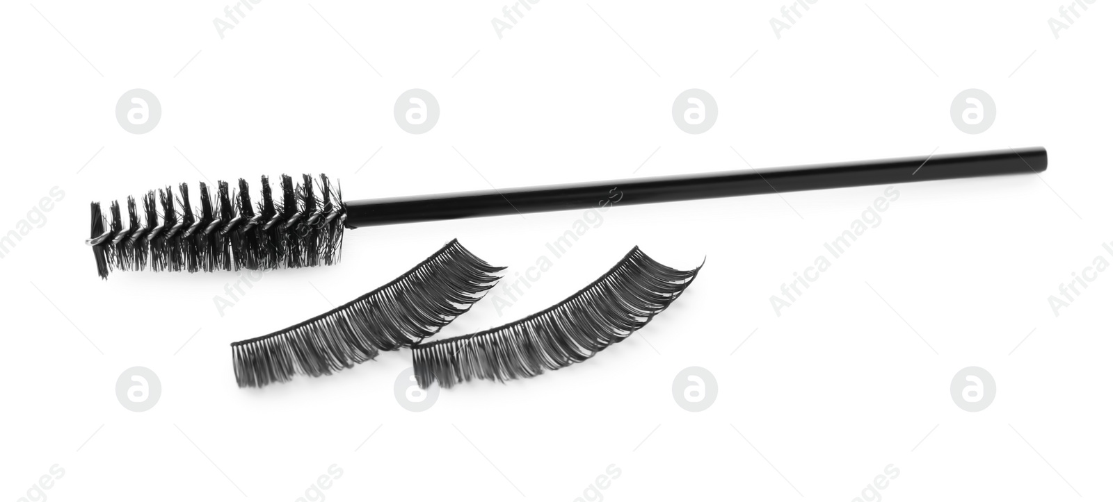 Photo of Fake eyelashes and brush on white background