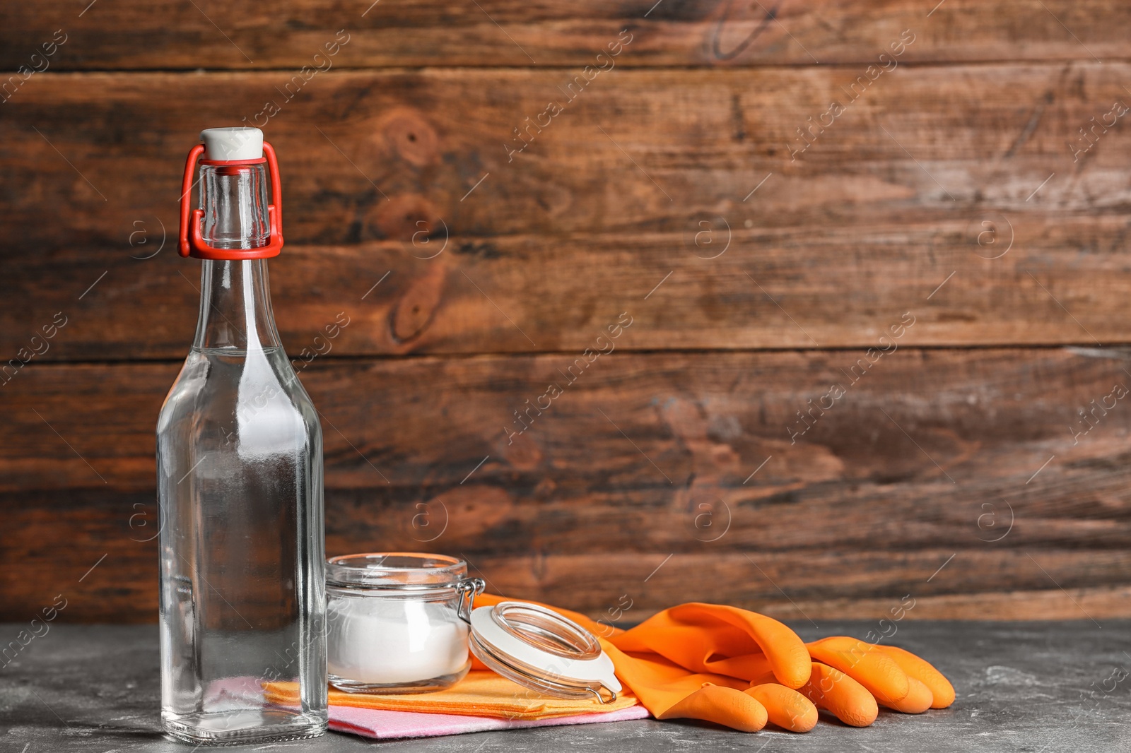 Photo of Composition with vinegar, baking soda and cleaning supplies on table