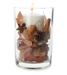 Photo of Burning candle and autumn decor in glass holder isolated on white