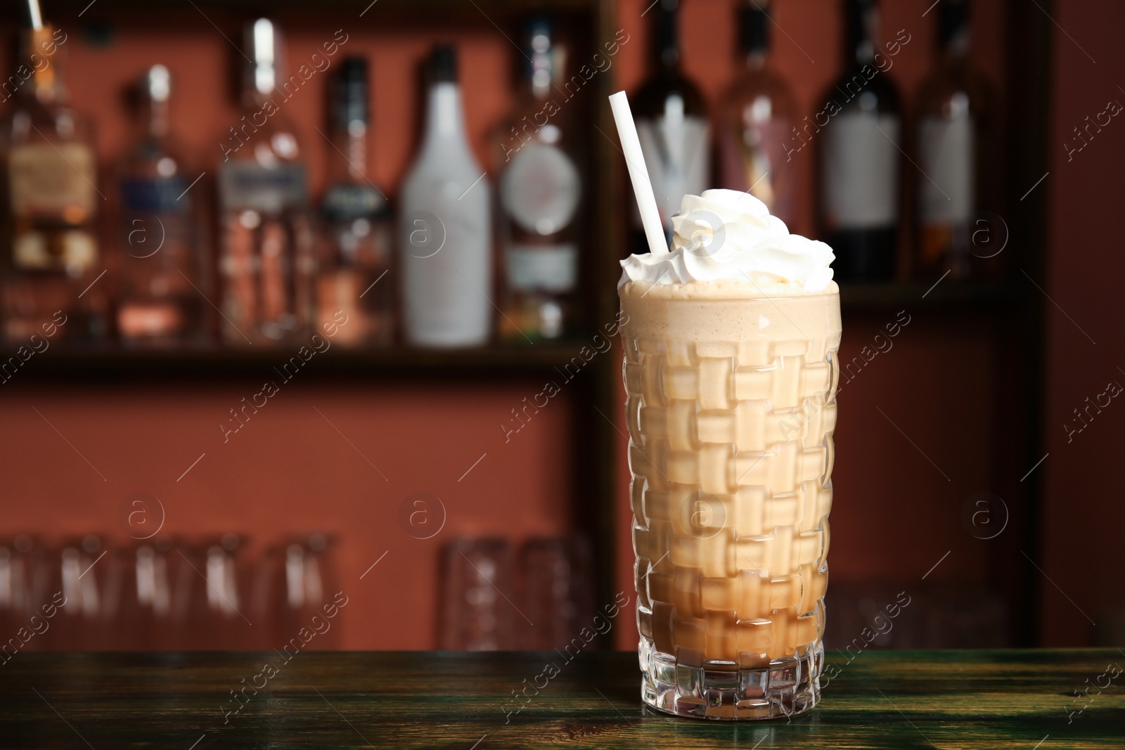 Photo of Glass with delicious cocktail on table in cafe