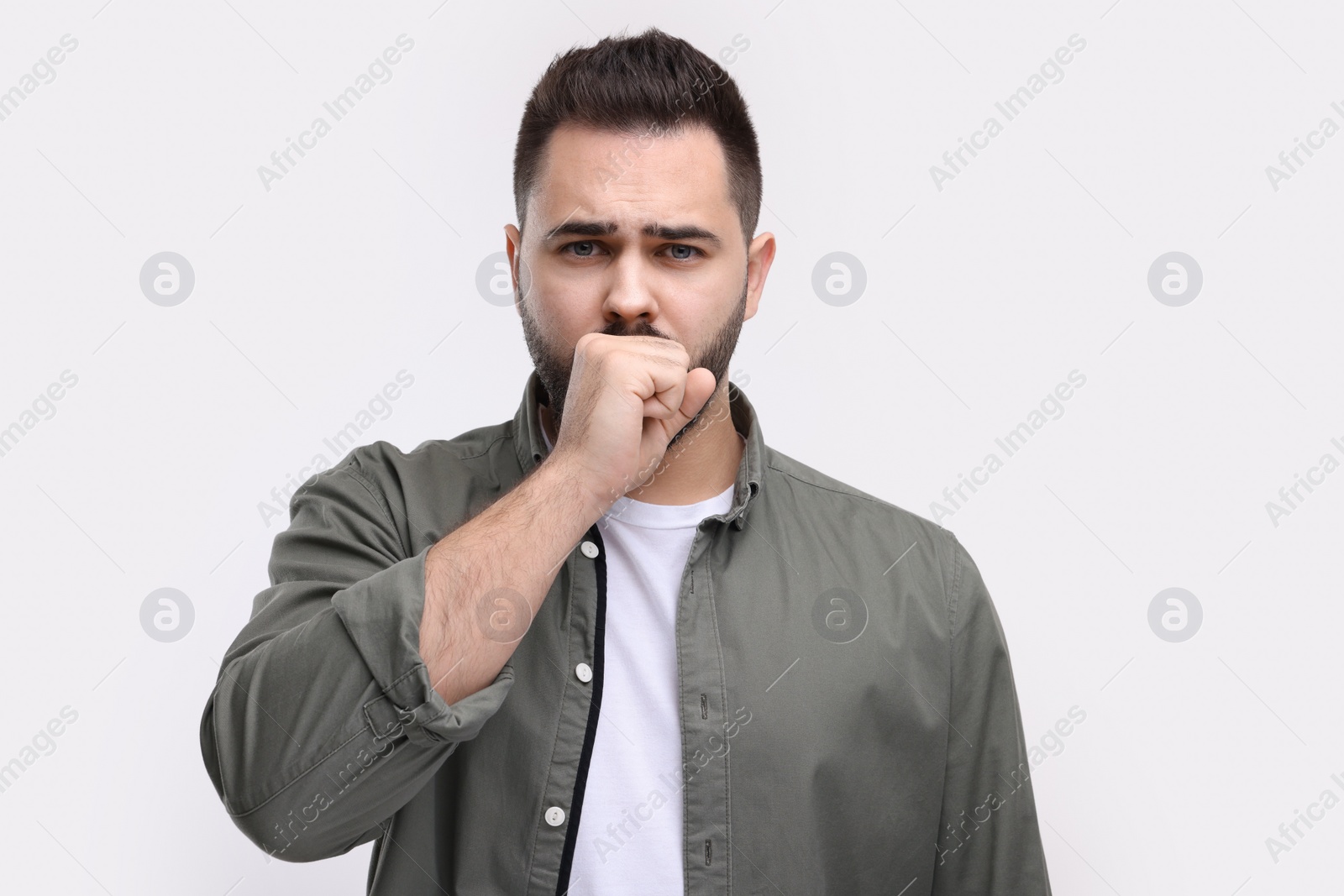 Photo of Sick man coughing on white background. Cold symptoms