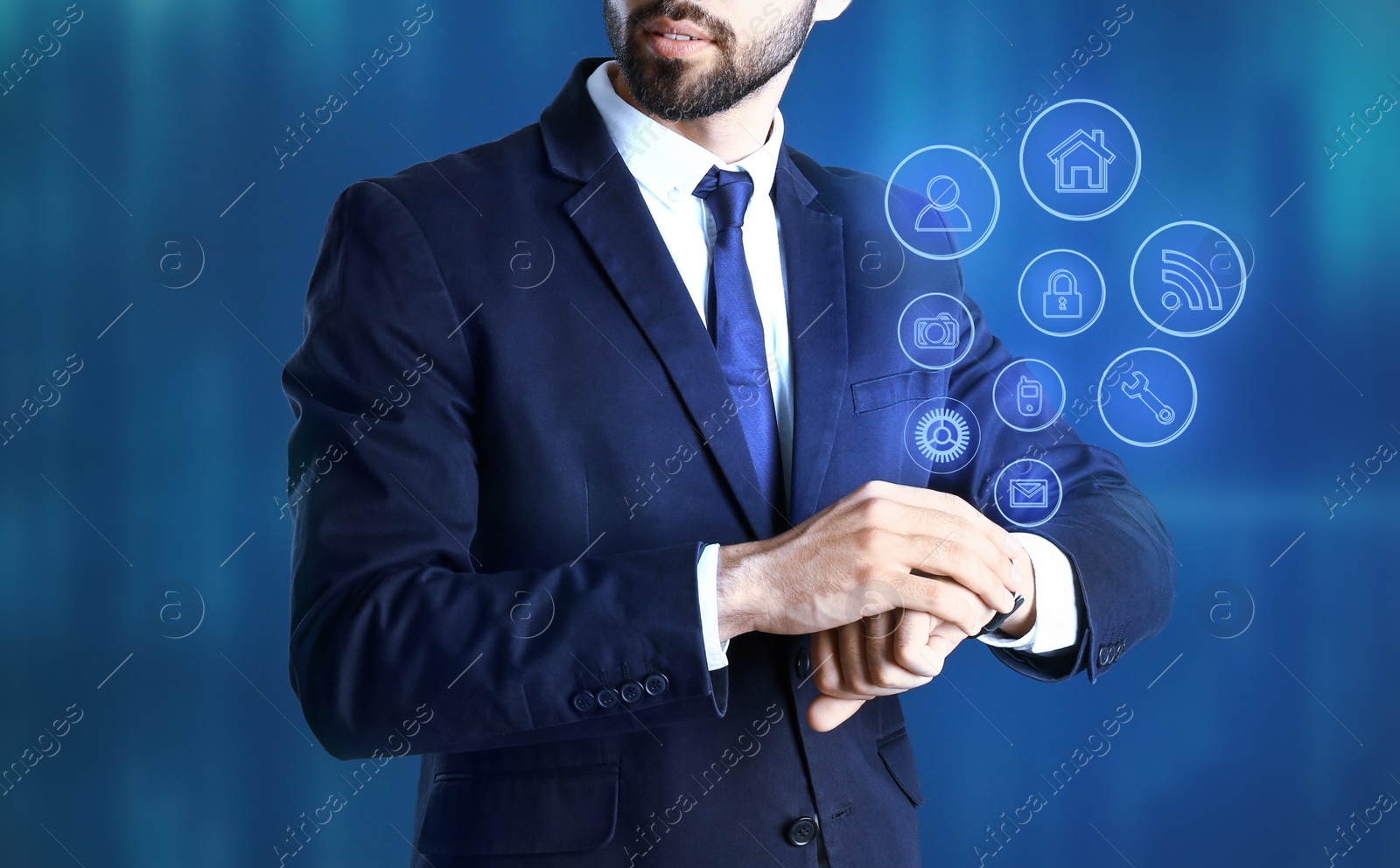 Image of Businessman with modern smartwatch on blue background 