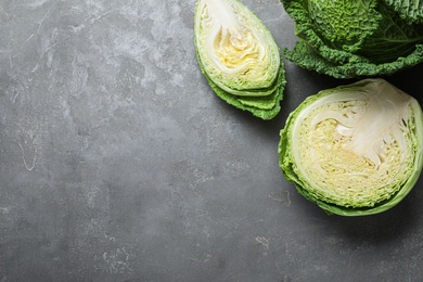 Fresh savoy cabbages on grey table, flat lay. Space for text