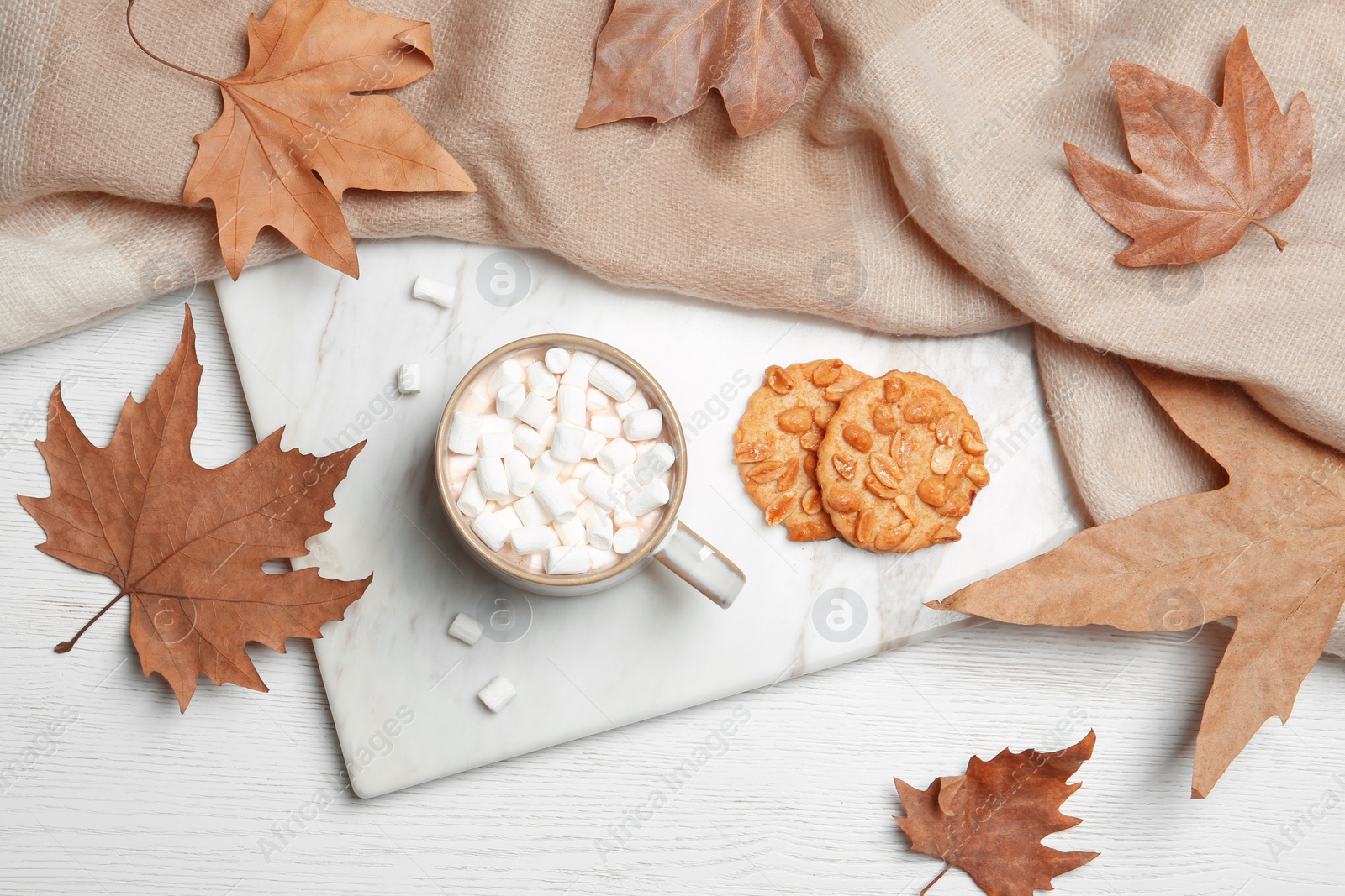 Photo of Flat lay composition with hot cozy drink and autumn leaves on wooden background