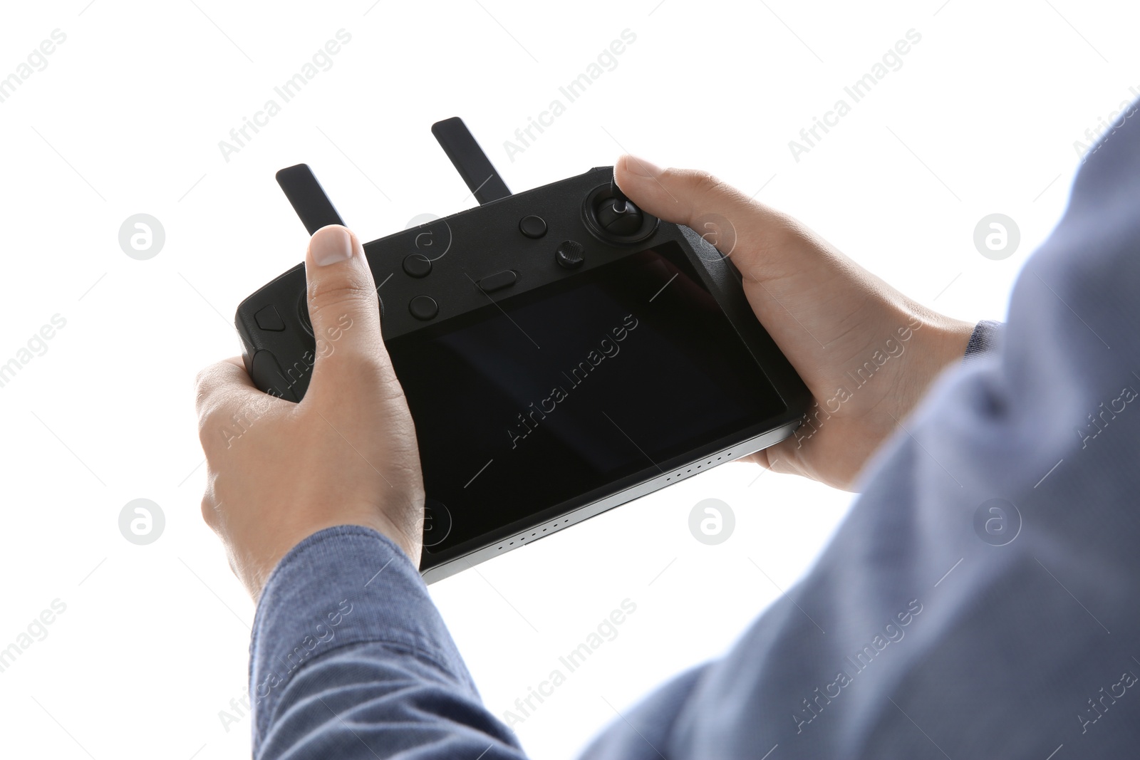 Photo of Man holding new modern drone controller on white background, closeup of hands