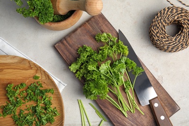 Flat lay composition with fresh green parsley on grey background