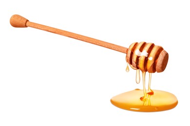 Natural honey dripping from dipper on white background