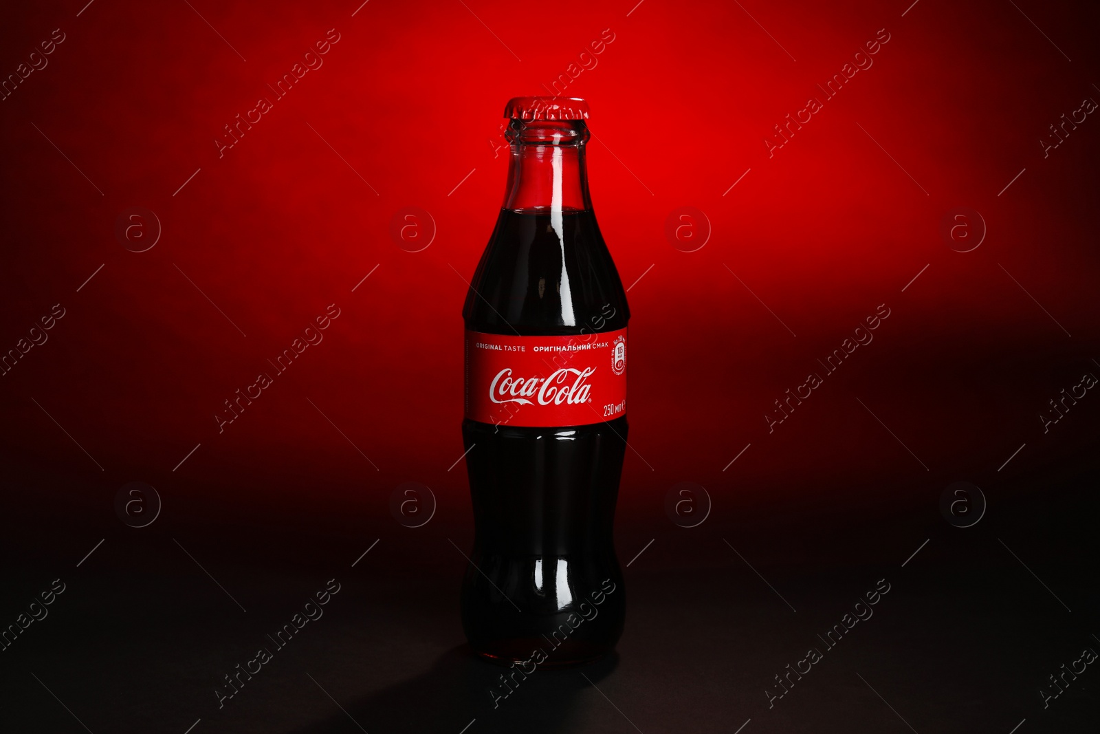 Photo of MYKOLAIV, UKRAINE - NOVEMBER 14, 2018: Bottle of Coca-Cola on color background