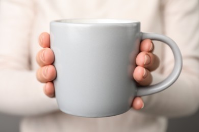 Photo of Woman holding mug of hot drink, closeup. Coffee Break